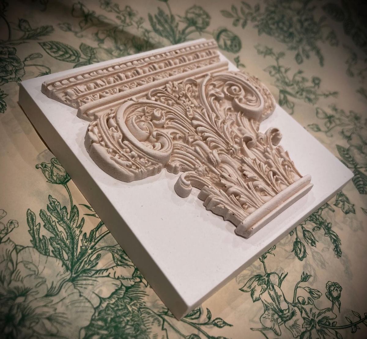 Corinthian plaster paperweight, signed and number. Aged plaster detail.