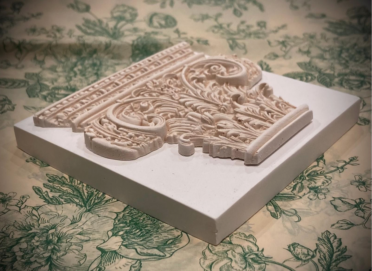 Corinthian plaster paperweight, signed and number. Aged plaster detail.