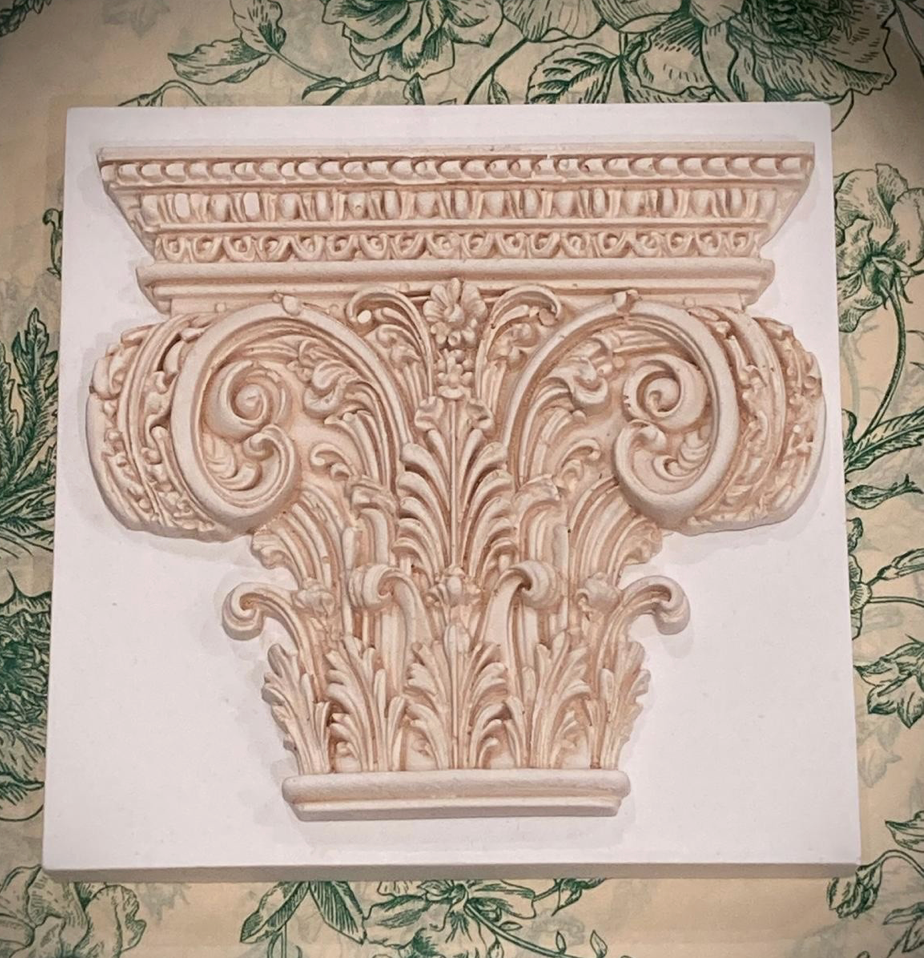 Corinthian plaster paperweight, signed and number. Aged plaster detail.