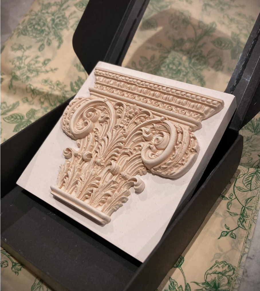 Corinthian plaster paperweight, signed and number. Aged plaster detail.