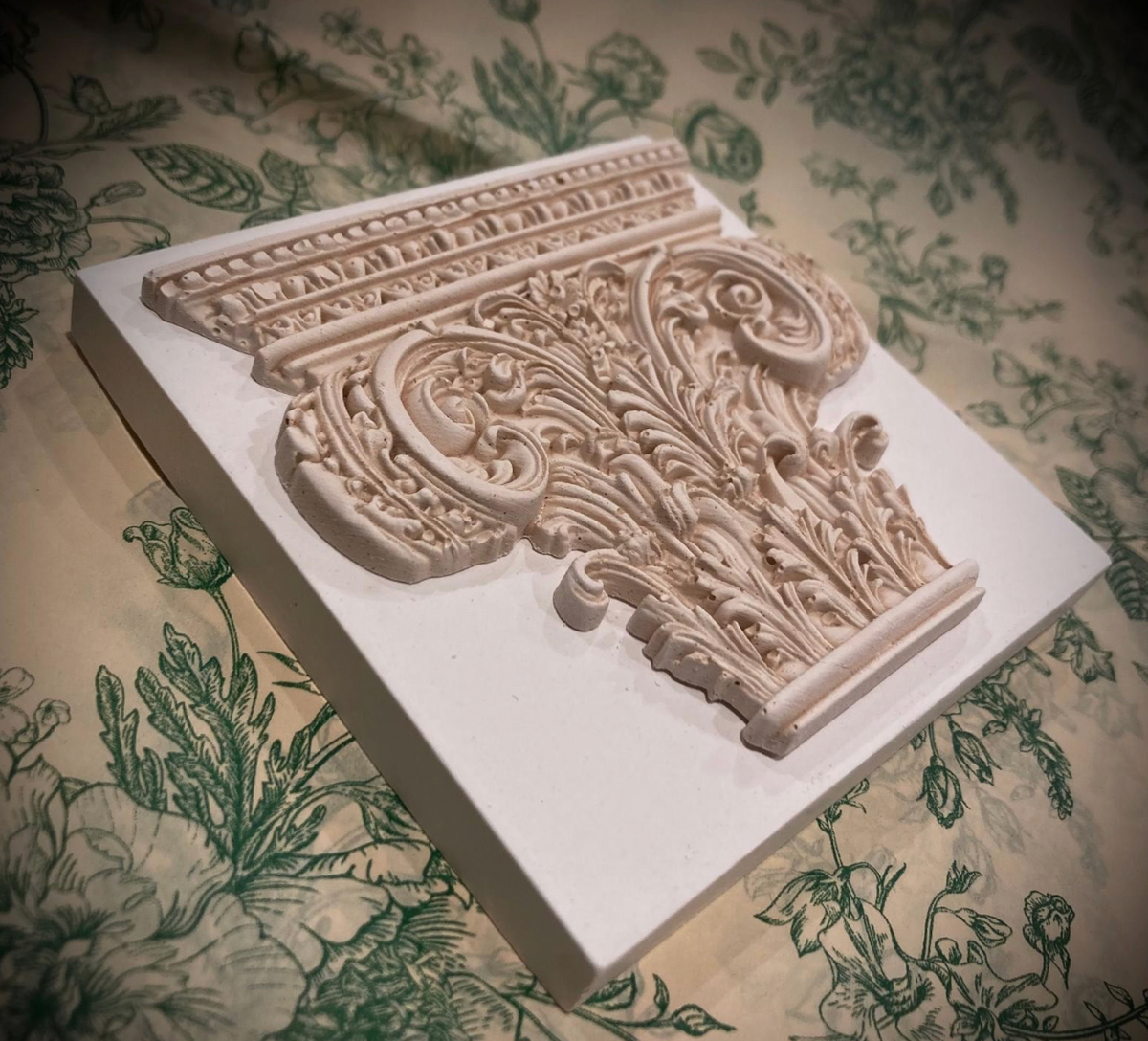 Corinthian plaster paperweight, signed and number. Aged plaster detail.