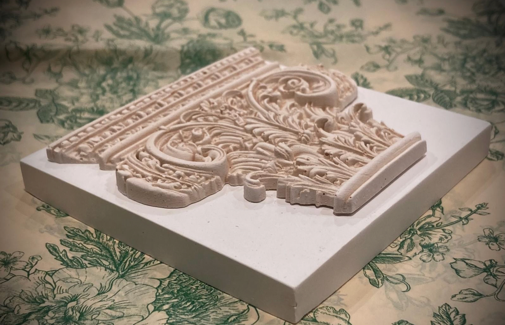 Corinthian plaster paperweight, signed and number. Aged plaster detail.